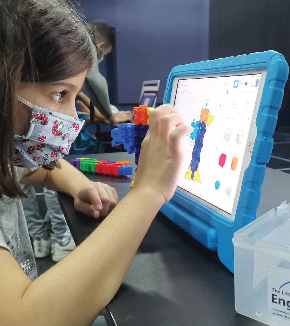 A child designing on a tablet during a 3D modelling session