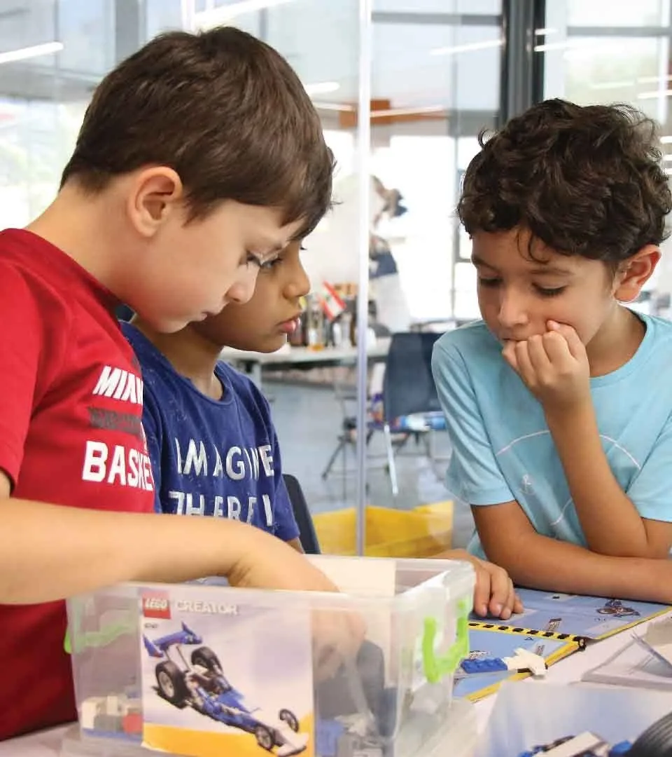 Children working on an engineering challenge together at a Little Engineer camp