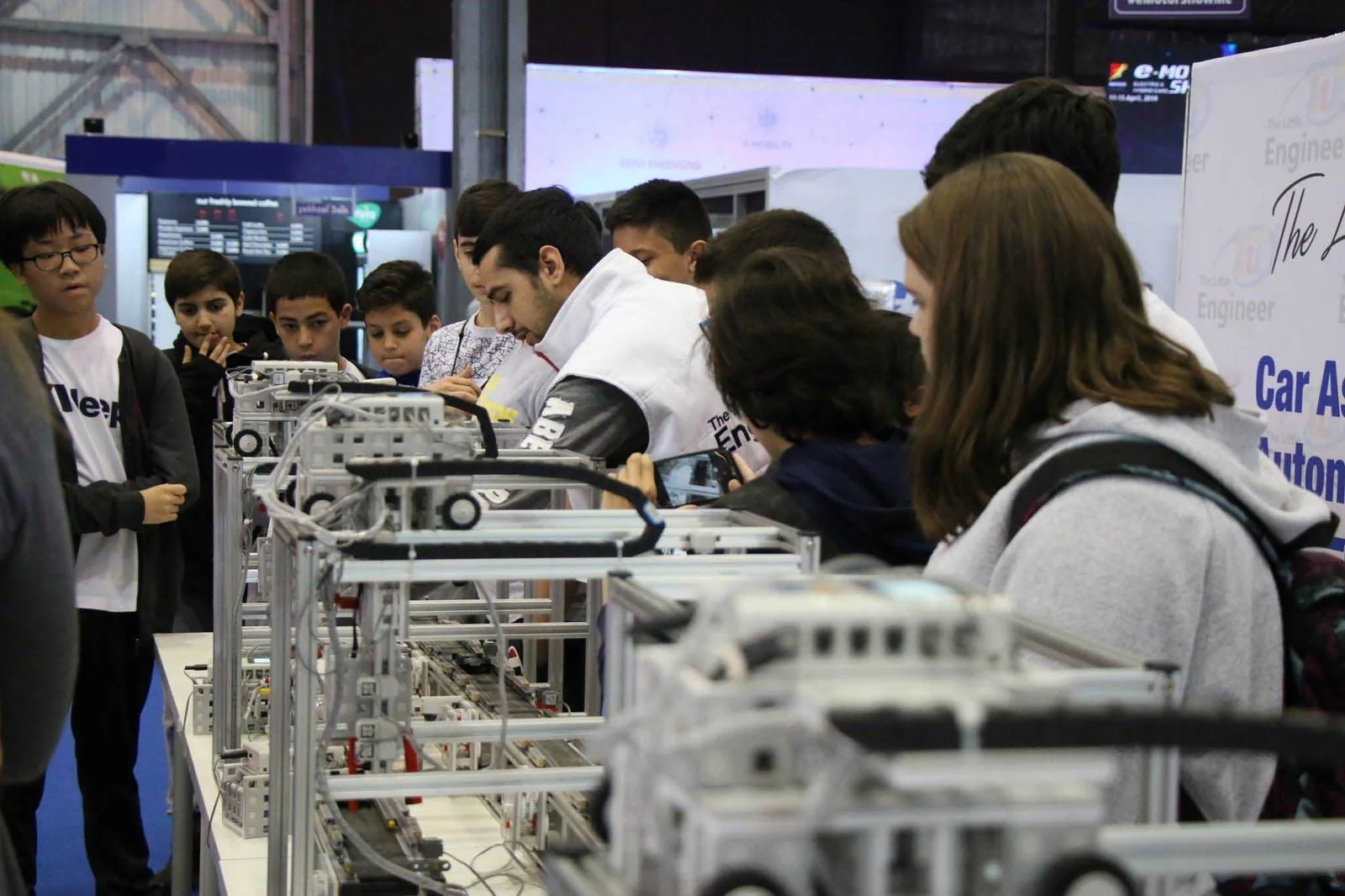 A large hall of engineering and robotics workstations at a Little Engineer event